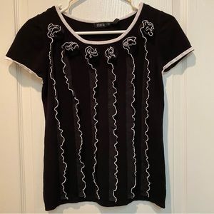 Striking Stera Black And White Sweater with Lace Rosette Vertical Ruffles